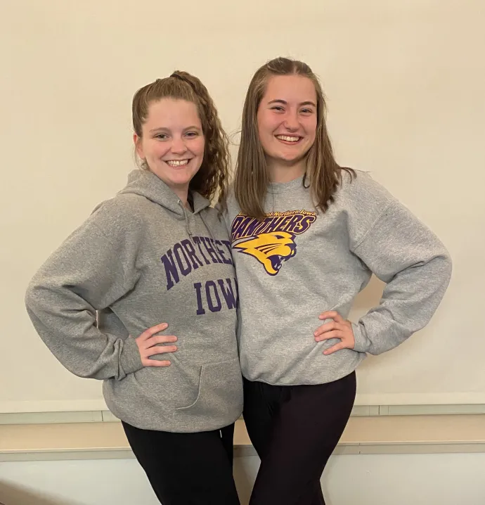 Kendra Morris and Ella Jensen, both wearing UNI sweatshirts