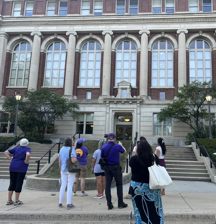 Participants in the architecture walking tours gather around Seerley Hall to learn about its history on campus.