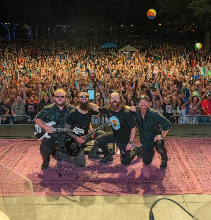 Pork Tornadoes posing on stage in front of crowd