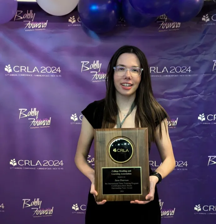 Sara Petersen holding award