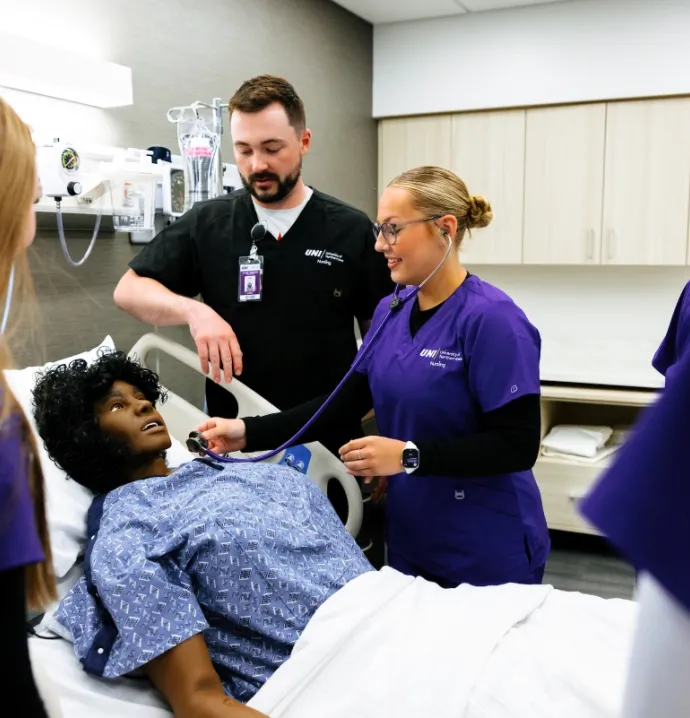 Nursing students working with labor and delivery simulator