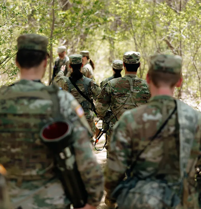 A picture of seven members of the UNI ROTC program, walking away from the camera