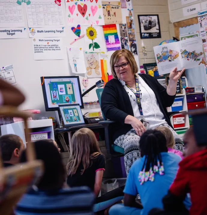 UNI grad student reading book to her young students in the classroom