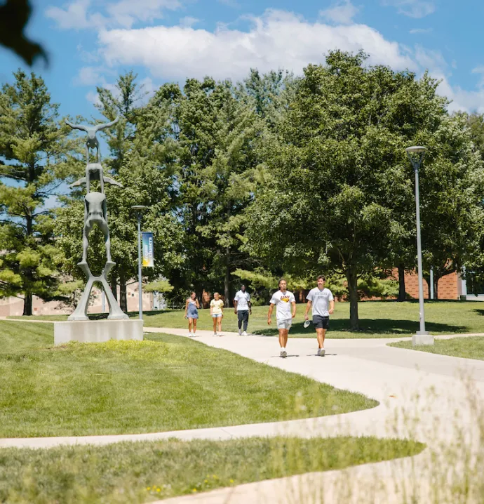 Students walking on UNI campus in the summer