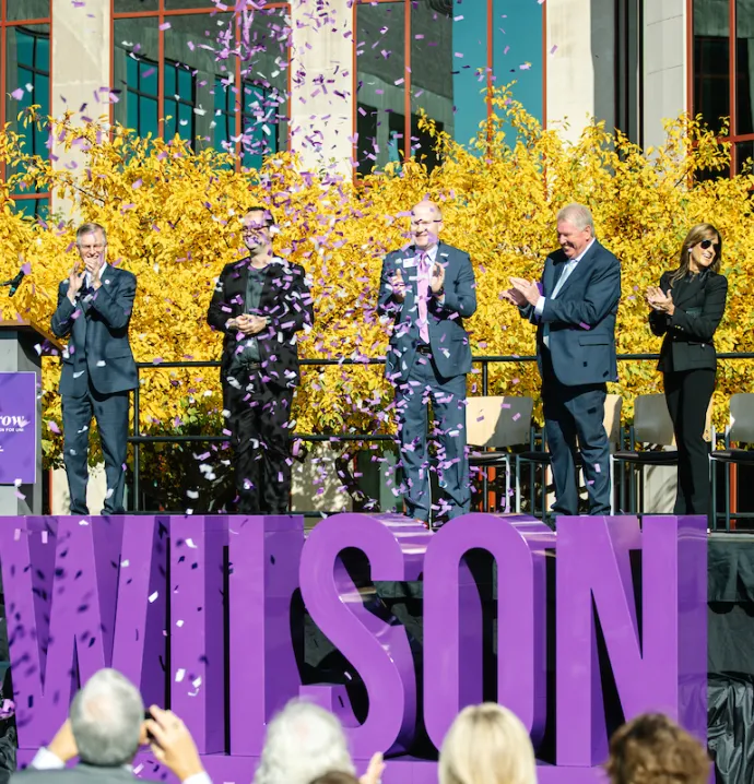 Confetti explodes around Wilson signage at announcement of $25 million donation