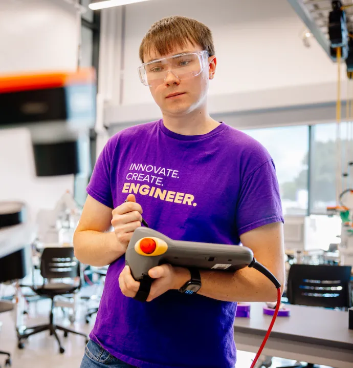 Elijah Yates working with robot in the Applied Engineering Building
