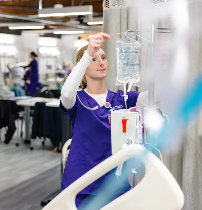 Nursing student prepping IV bag
