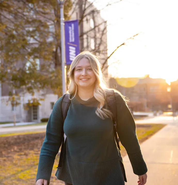 Student walking on UNI campus
