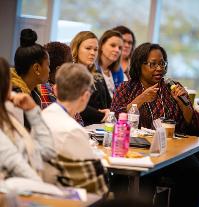 Audience member asks question at System of Support Conference