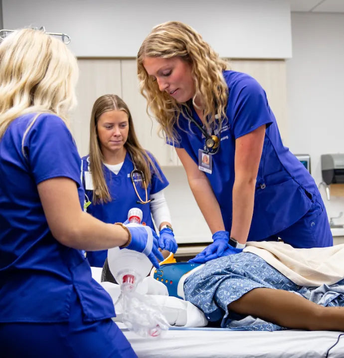Nursing students provide care for medical manikin