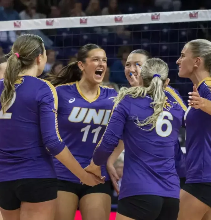 UNI volleyball players celebrate win