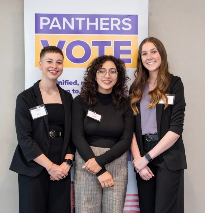 Women in Politics scholarship recipients in front of Panthers Vote sign