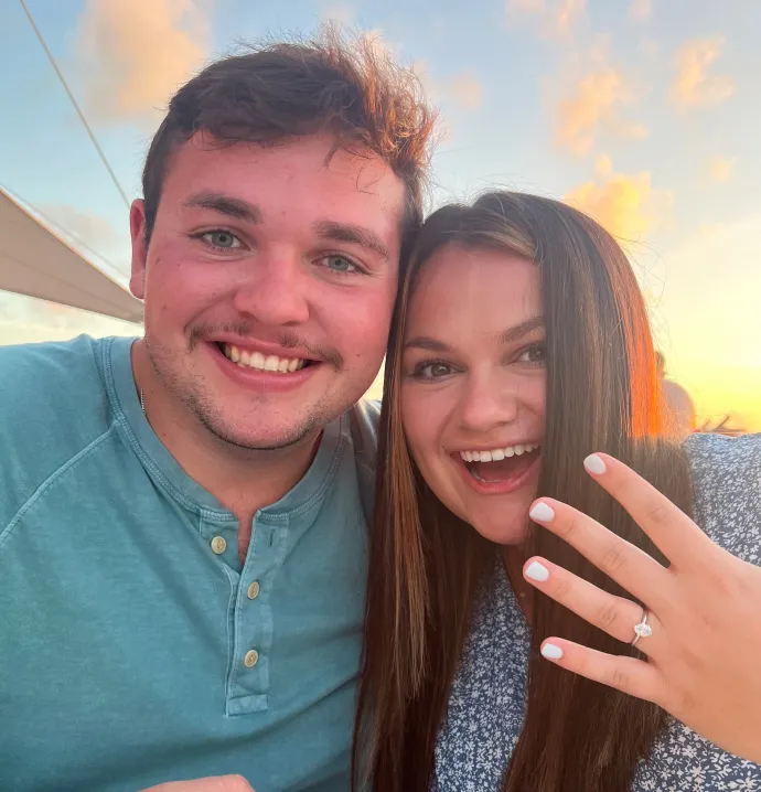 Ethan Arnold and Mallory Burdt with Mallory showing engagement ring