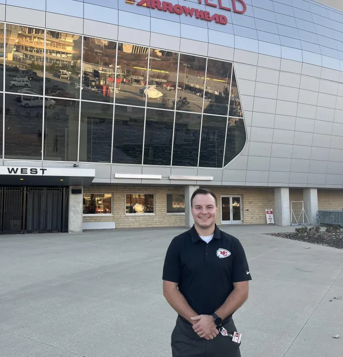 Aaron Dzaboff in front of Geha Field Arrowhead wearing a Chiefs polo