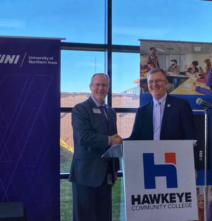 Hawkeye Community College President Todd Holcomb and UNI President Mark Nook shaking hands