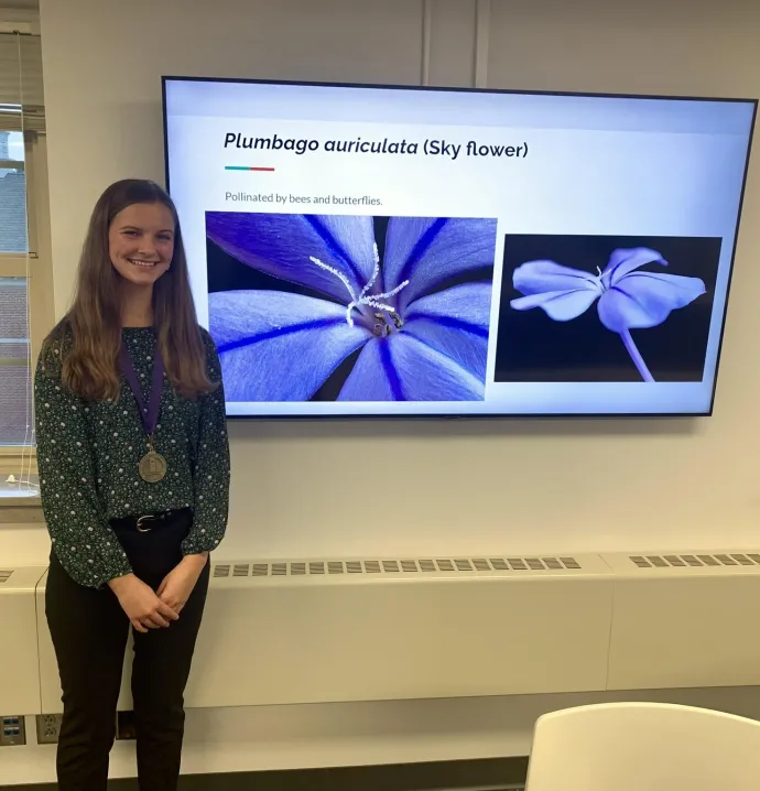 Bethany Van Dusseldorp in front of her research