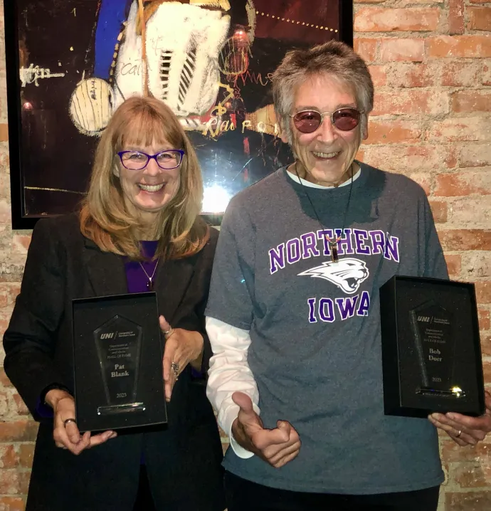 Pat Blank and Bob Dorr holding up Department of Communication and Media Hall of Fame awards