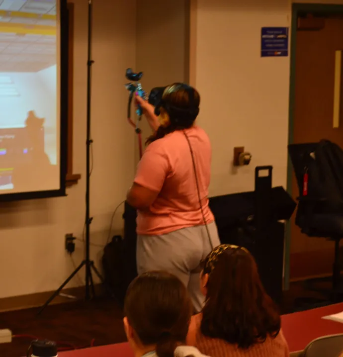 Woman demonstrates spray painting simulator