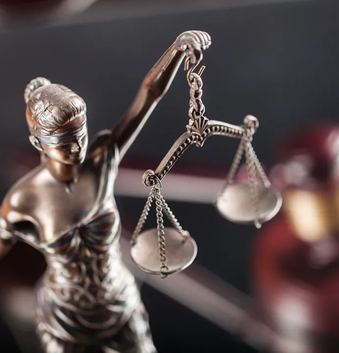 Statue of Lady Justice holding balanced scales