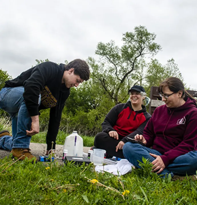 Members of Green Iowa AmeriCorps take a water sample.