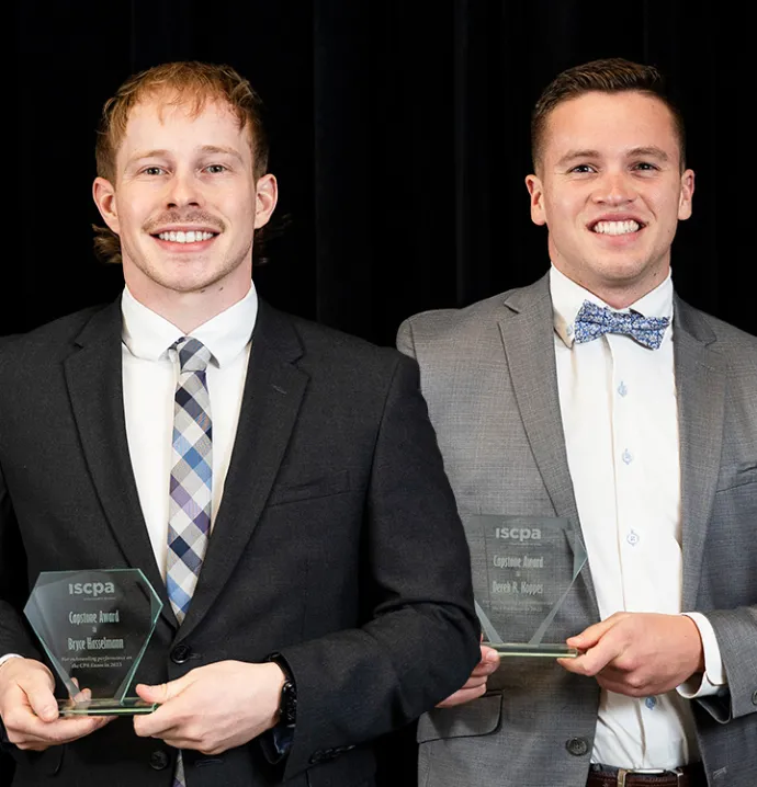 Bryce Hasselman and Derek R. Koppes holding Capstone Awards