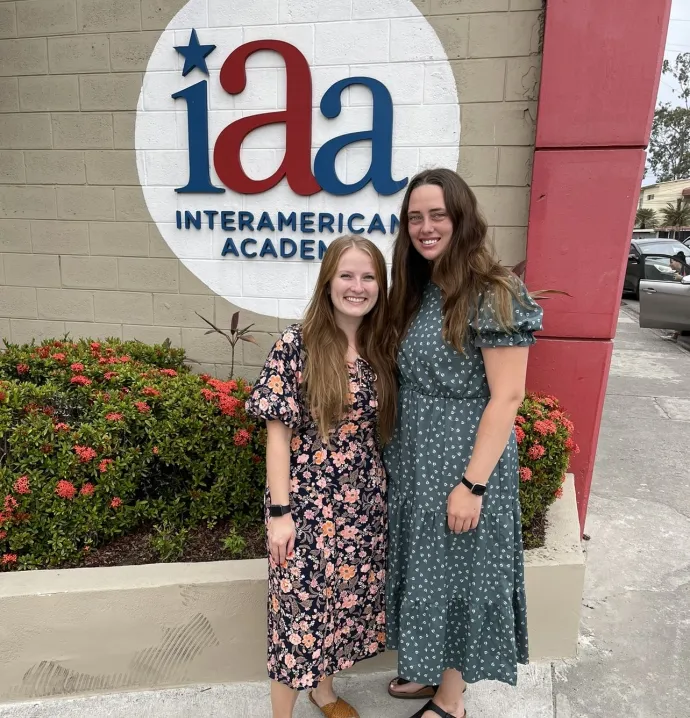 Emmalee Fannon and Cassey Bly in front of InterAmerican Academy