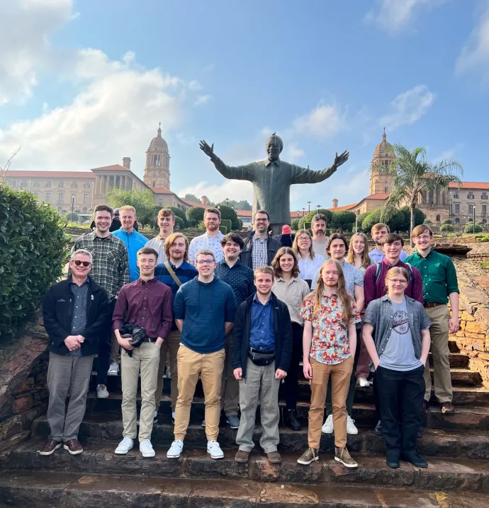 Jazz Band One standing in front of a statue of Nelson Mandela