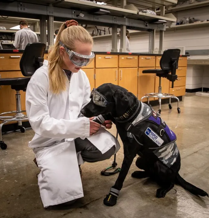 UNI student Jacey Meier with the service dog, Raven, she is training.
