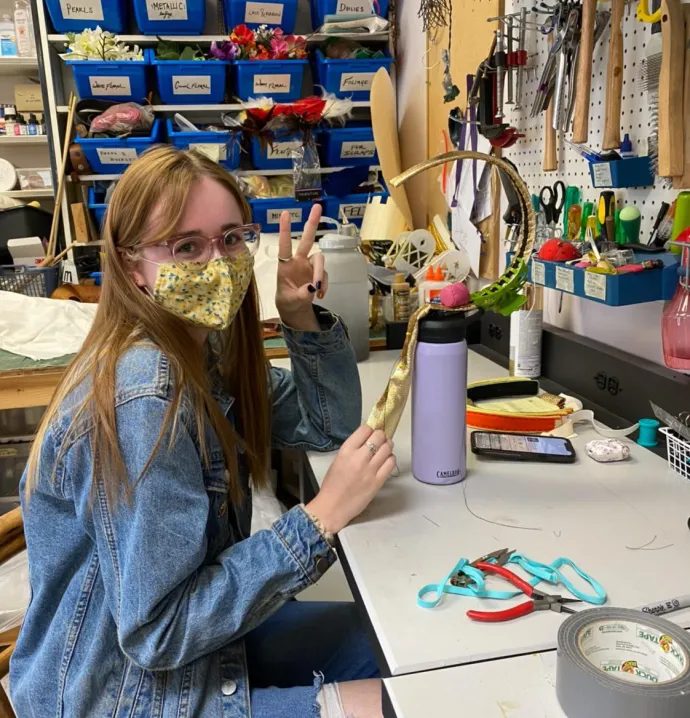 Lydia Burg working on costume prop at desk