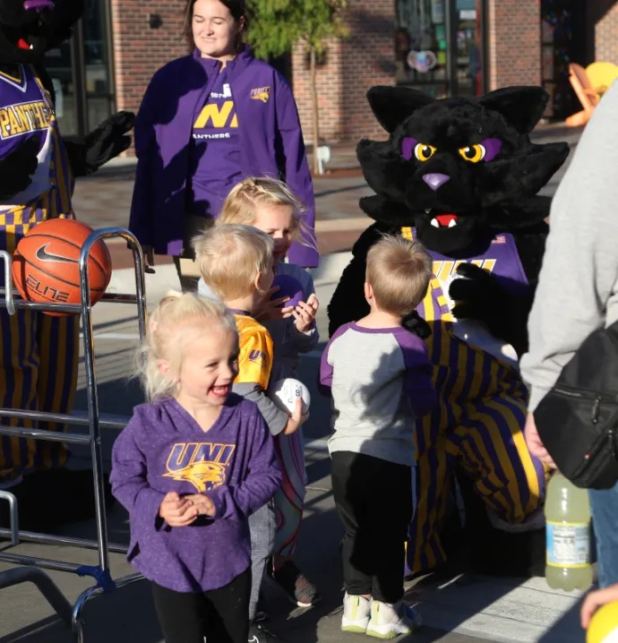 TC mascot and children playing with basketballs