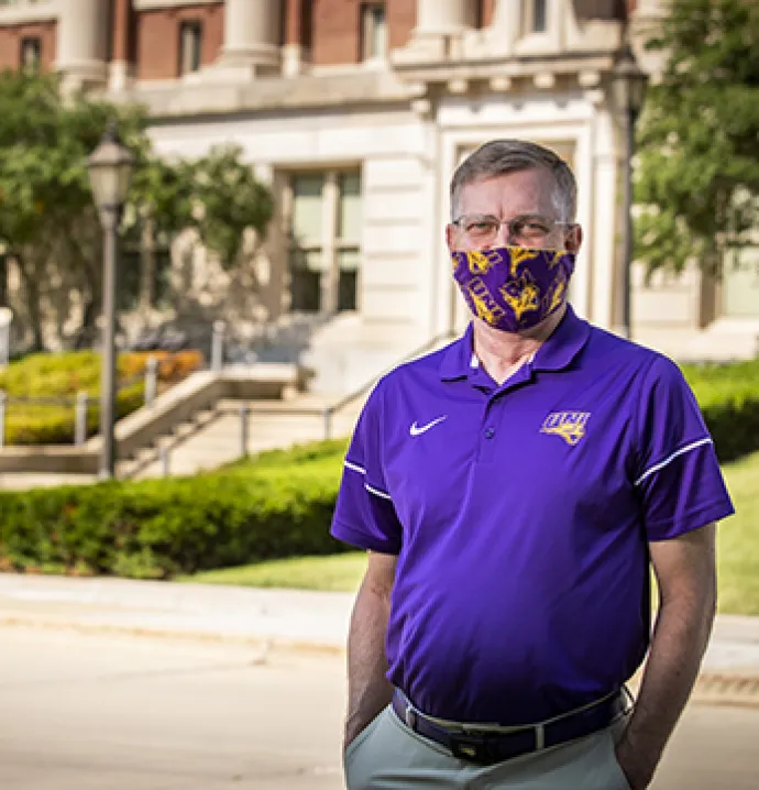 UNI President Mark A. Nook wears a mask on campus.