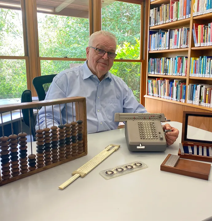 Math alum Calvin Irons sitting at desk 