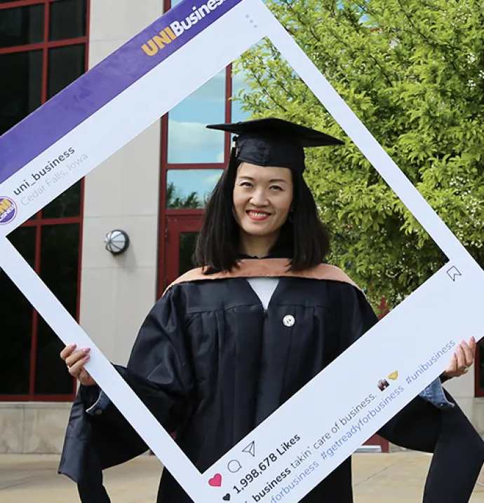 International MBA student in front of Curris Business Building at the University of Northern Iowa