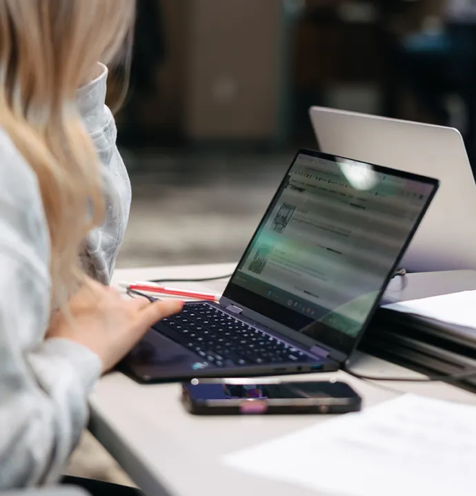 Student doing research using AI on laptop