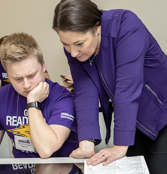University of Northern Iowa accounting instructor Linda Debarth helps a business student 