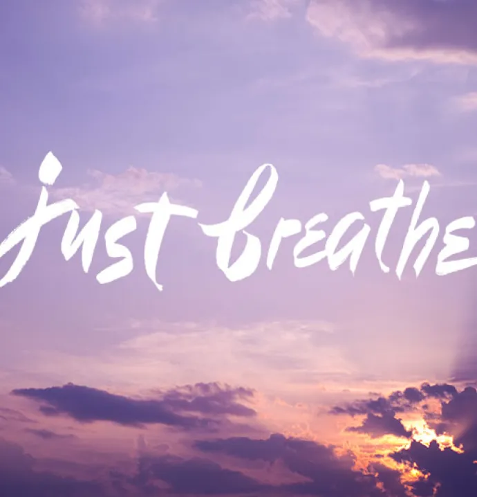 just breathe typography on purple sky
