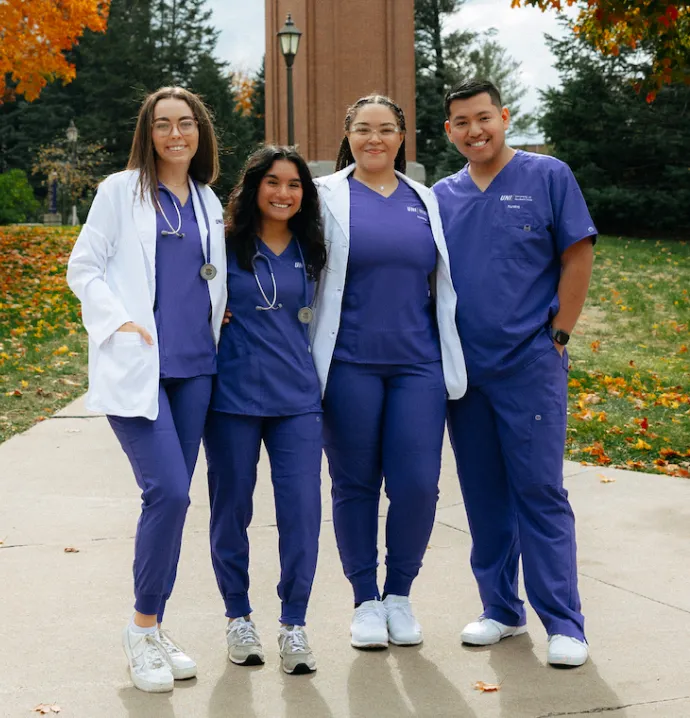 Students in UNI nursing apparel in front of campanile