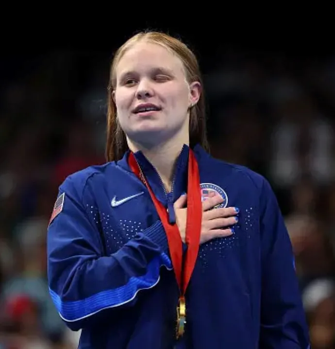 Olivia Chambers wearing gold medal at medal ceremony 