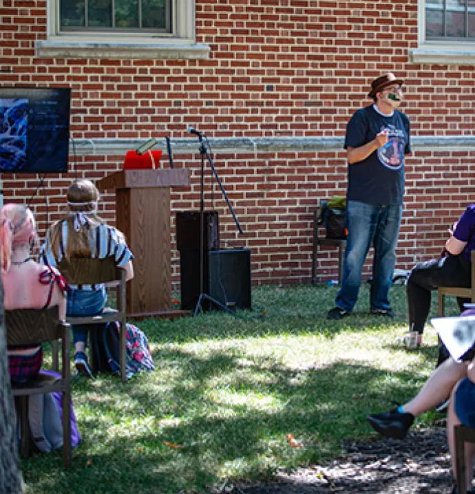 UNI languages and literature professor Grant Tracey teaches a class outside.