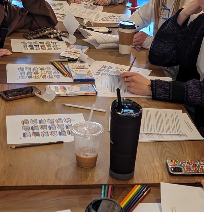 Death cafe participants coloring at a table