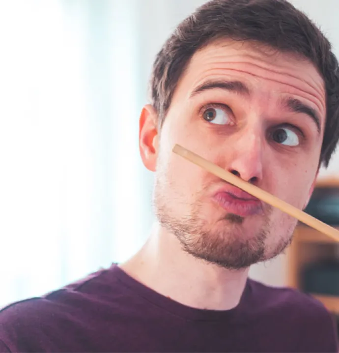 guy goofing around at home with a pencil