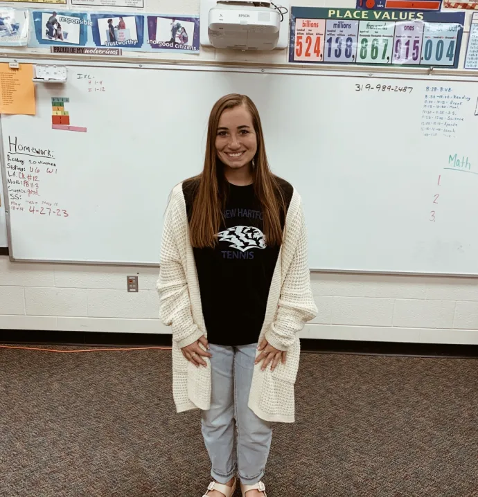 Reegan Zinkula standing in front of a white board in her classroom