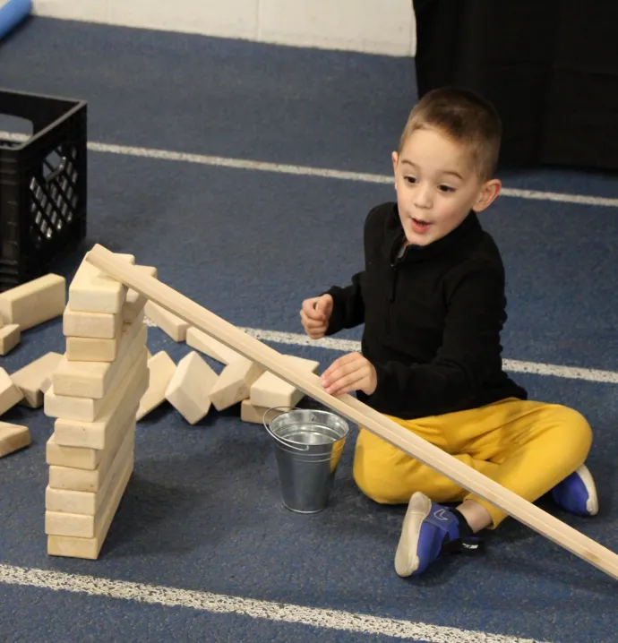 Child builds ramps and pathways at Cedar Valley STEM festival