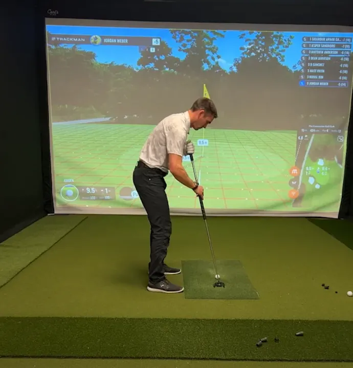 Jordan Weber golfing using golf simulator