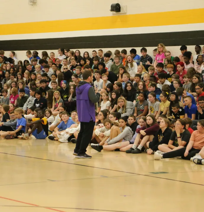 Wrestling coach Doug Schwab speaks to sixth grade students