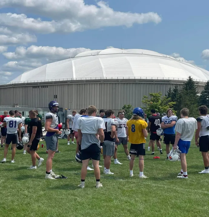High school football players standing outside UNI-Dome