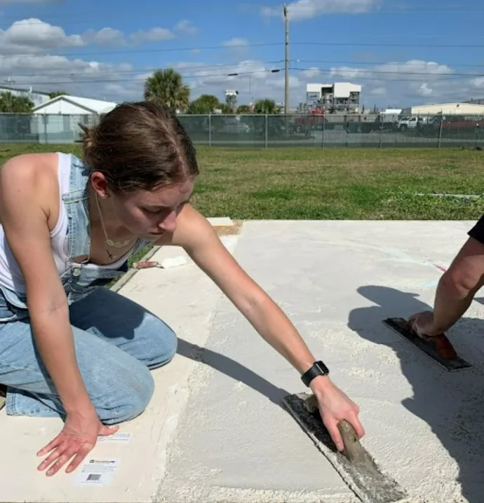 Rachel Heine smoothing out concrete