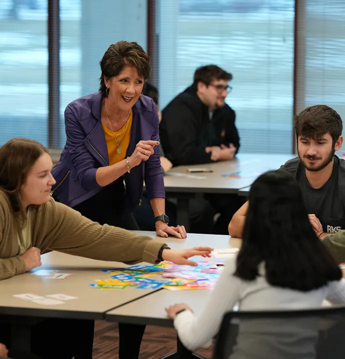  Instructor guiding students during a session of the Professional Readiness Program, offering support and career advice.