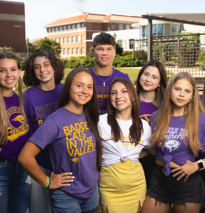 Eight Ukrainian students on UNI campus wearing Panther gear