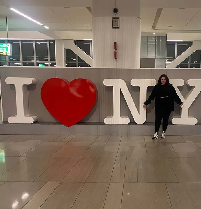Student in front of I love NY sign
